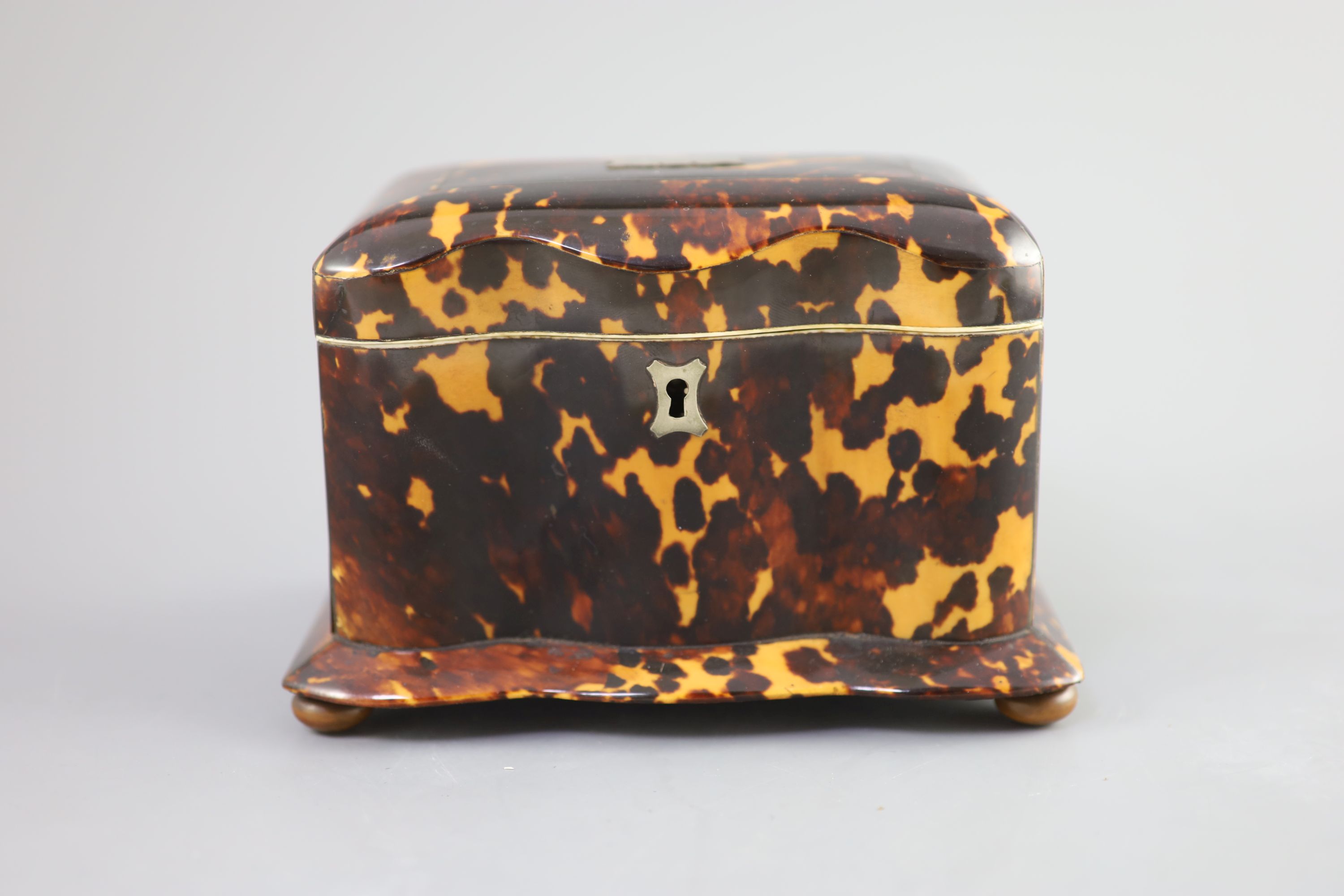 A 19th century tortoiseshell tea caddy, 18cm wide, 11cm deep, 11.5cm high.